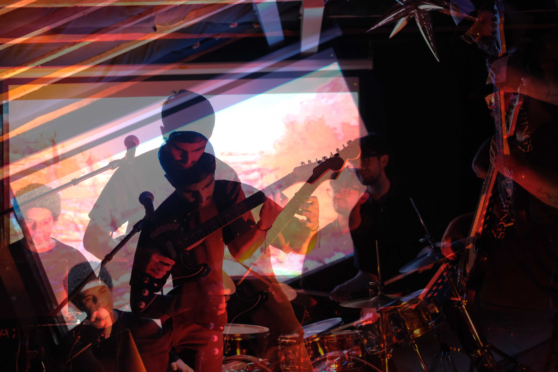 Double-exposure photo of the band mid-set